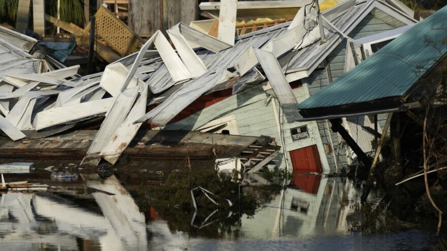 A home that came off its blocks sits partly submerged in a canal in Horseshoe Beach on Friday, Sept. 1, 2023, two days after the passage of Hurricane Idalia.