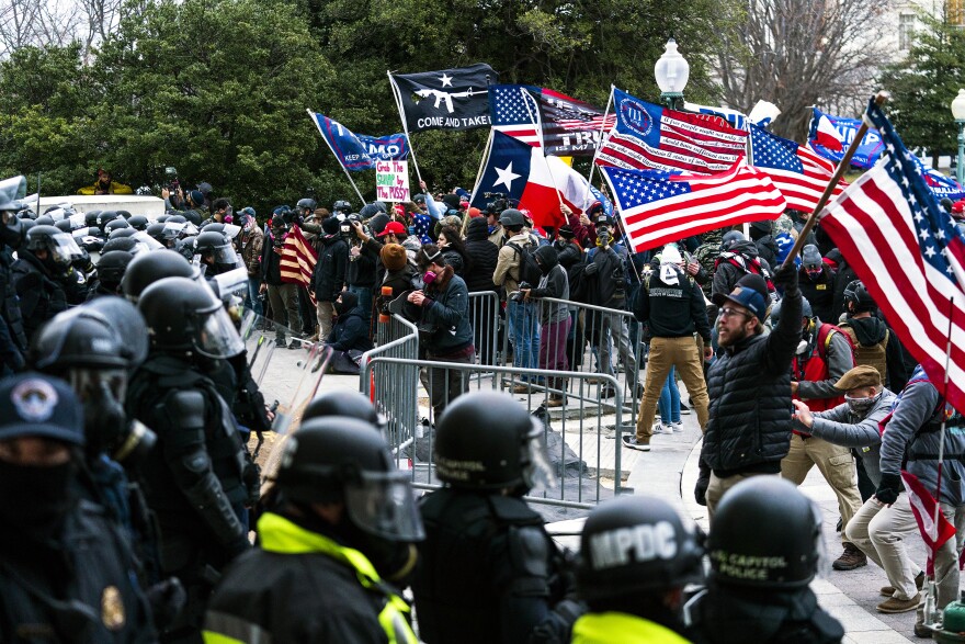 Supporters of President Donald Trump are confronted by U.S. Capitol Police officers outside the Capitol, Wednesday, Jan. 6, 2021, in Washington. 