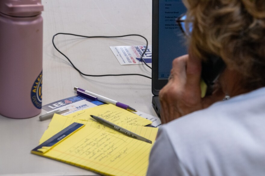 A volunteer reads off her own handwritten notes as she phone banks for candidates out of the Allen County Democratic Party headquarters.