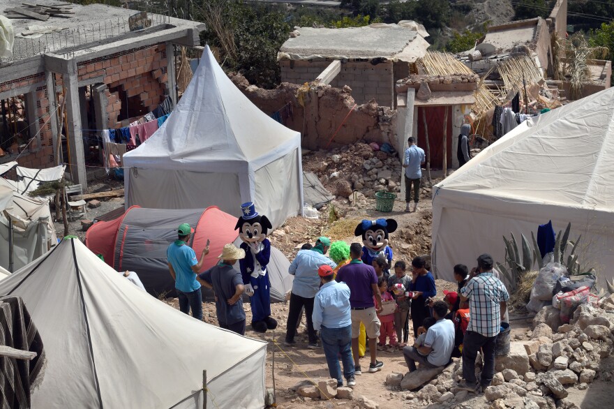 Members of a Moroccan scouts' association dress in costumes to entertain child survivors of the earthquake in Imi N'Tala, Morocco, on Sept. 17.