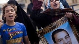 Supporters of Mubarak in Cairo chant slogans and carry his portrait as they demonstrate in February during his trial, outside the police academy.