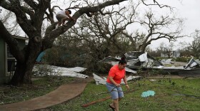 Joshua Nguyen (left) and Deserae Garcia clean up around their home after Hurricane Harvey passed through on Aug. 27, 2017 in Rockport, Texas. (Joe Raedle/Getty Images)