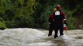 Indianapolis firefighters rescued two boys who were swept into Fall Creek on Monday.
