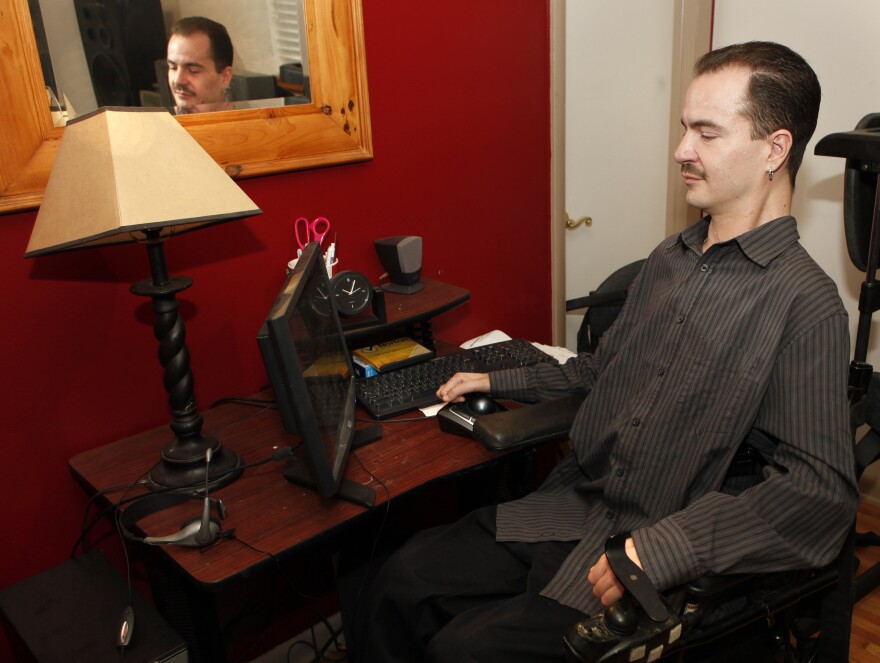 Brandon Coats works on his computer at his home in Denver in December 2012.