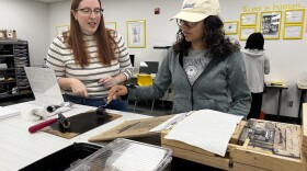 Katie Lanning, an associate professor of English at Wichita State University, helps a student use a Book Beetle machine, which mimics a full-size Gutenberg press. A new Book Technologies Lab at WSU was funded by a donation from Lanning's family in honor of her late grandfather, Robert L. Cattoi.