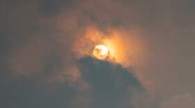 The Sun peeks through the clouds and yellow haze of wildfire smoke over the Boston area on Wednesday morning. (Jesse Costa/WBUR)