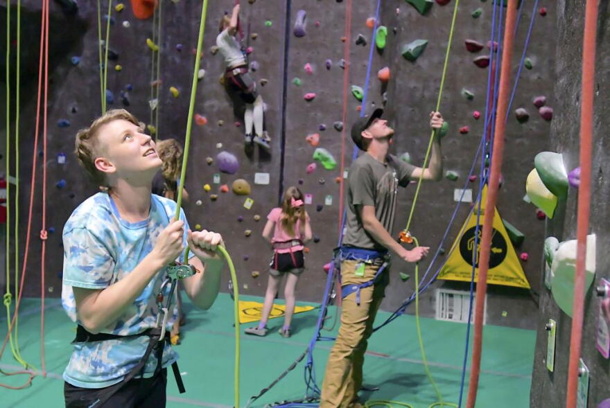 Madison Ward, sister of JJ Ward, belays a climber at Elevation Rock Gym on Friday.