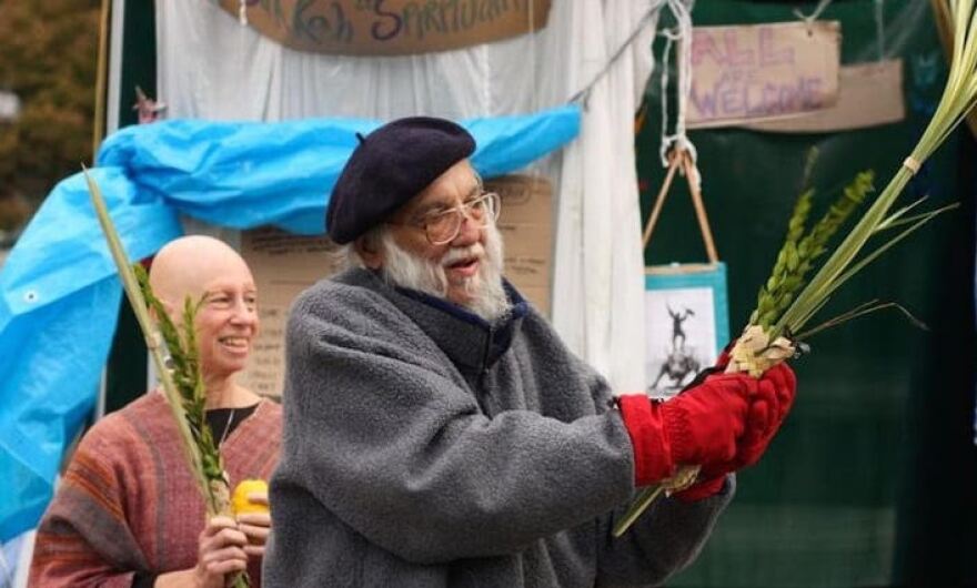 Photo of Rabbi Waskow benching Luvav from Slate.com;