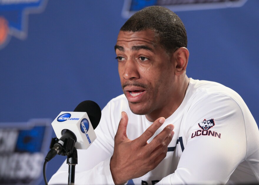 Former Connecticut coach Kevin Ollie speaks during a news conference ahead of a second-round men's college basketball game in the NCAA Tournament in Des Moines, Iowa, March 18, 2016. An independent arbiter has ruled that UConn improperly fired former men's basketball coach Kevin Ollie and must pay him more than $11 million, Ollie's lawyer said Thursday, Jan. 20, 2022.