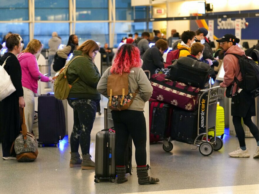 Passengers check in at Southwest Airlines' self-serve kiosks at Chicago's Midway Airport as delays stemming from a computer outage at the Federal Aviation Administration brought flights to a standstill across the U.S. on Jan. 11.