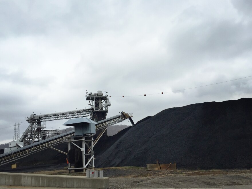 Coal from neighboring mines arrives at the Powhatan Transportation Center by train and truck. The coal from this stockpile goes onto a conveyor belt and drops down a chute before being loaded onto a barge for distribution across the Ohio River.
