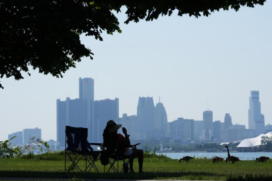 A woman sits in the shade on Monday, July 13, 2026, in Detroit. (Paul Sancya/AP)