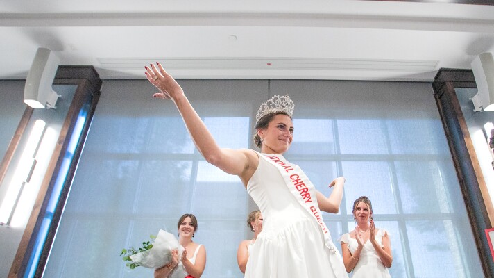 Magdalen Kleinrichert reacts after being crowned the 2026-27 National Cherry Queen by outgoing queen Ainslee Hewitt during Friday’s National Cherry Festival Queen’s Coronation at the Park Place Hotel in Traverse City.
