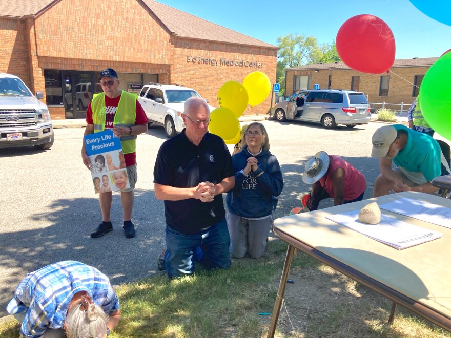   People who oppose abortion rights kneel in prayer after the end of Roe v. Wade