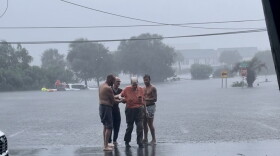 Mitchell McDowell, right, helped rescue a family of three from a flooded truck Monday morning.