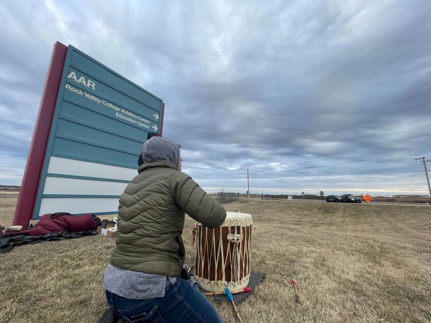 Jessie Crow-Mermel drums along while watching the Rockford airport's bulldozers strip the prairie.