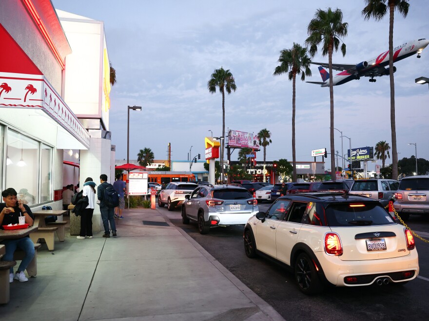 A Delta Airlines plane lands near an In-N-Out Burger next to Los Angeles International Airport on Thursday.