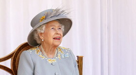 FILE - Britain's Queen Elizabeth II watches the red arrows fly over to mark her official birthday at Windsor Castle, Windsor, England, Saturday June 12, 2021.