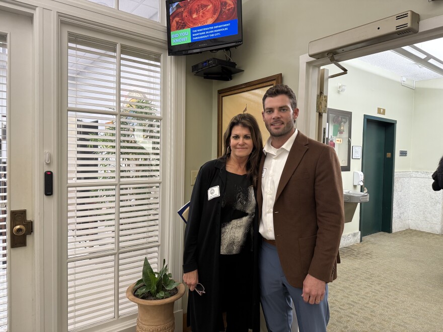 A mother and son pose for a photo standing in Tampa city hall. 