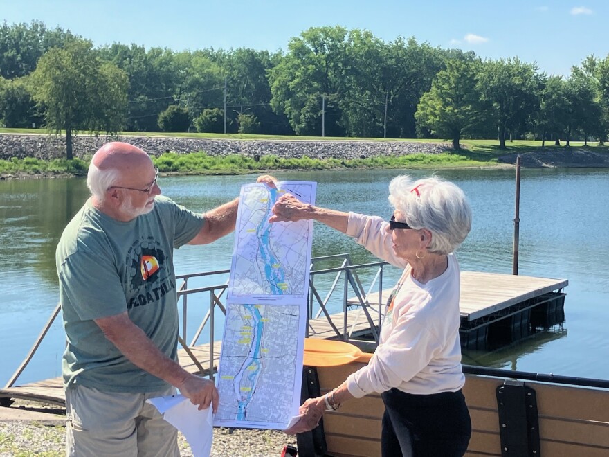 Jeff Leonard and Kathy Wine point out the eight Floatzilla launch sites along the Mississippi River, at a July 14 press conference at Lake Potter, Rock Island.
