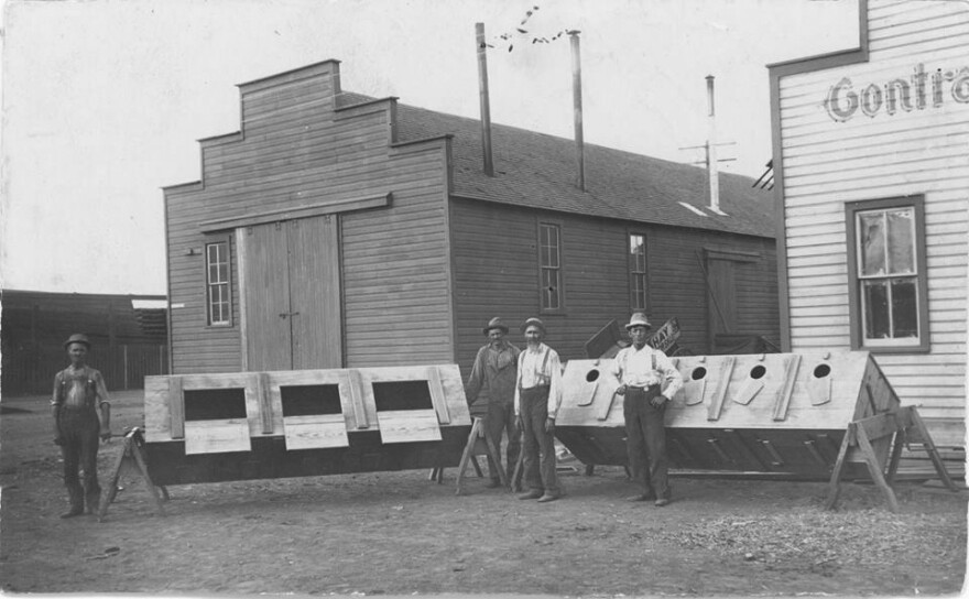 Men stand in front of the lottery boxes in 1901, awaiting the anticipated drawing for the opening of KCA lands.