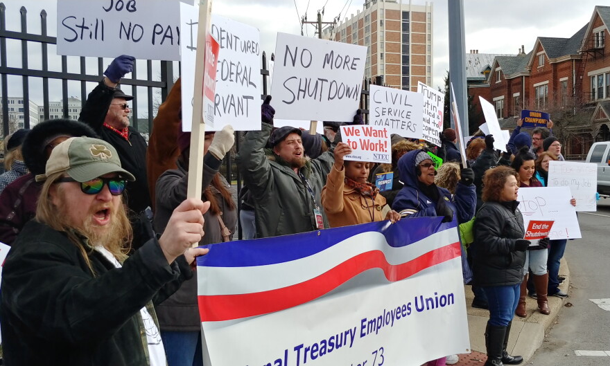 Demonstrators chanted slogans like "Open us up so we can get paid."
