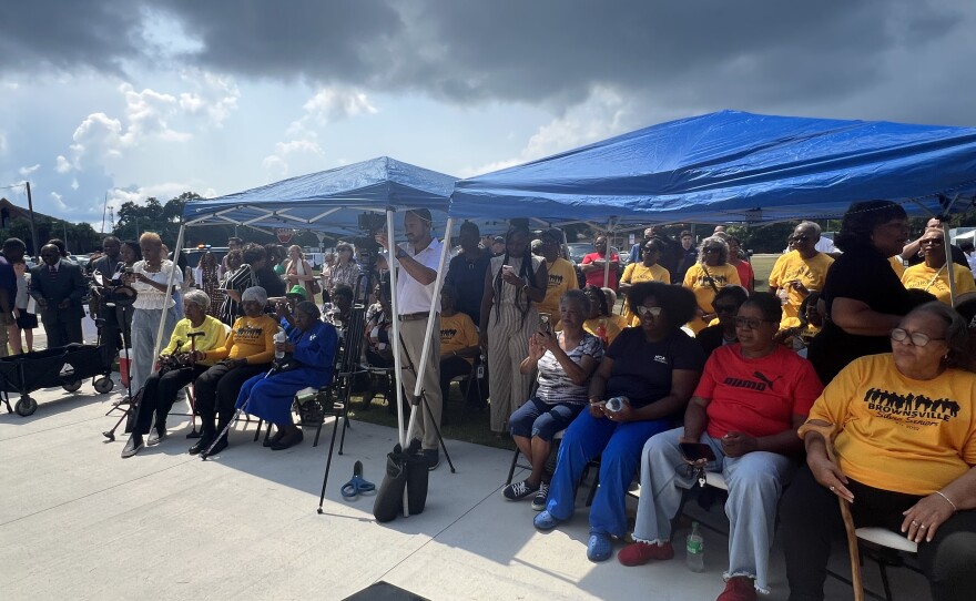 The crowd gathers for the Brownsville Library’s opening ceremony. Members of the Brownsville Silver Seniors are easily spotted in their yellow shirts.