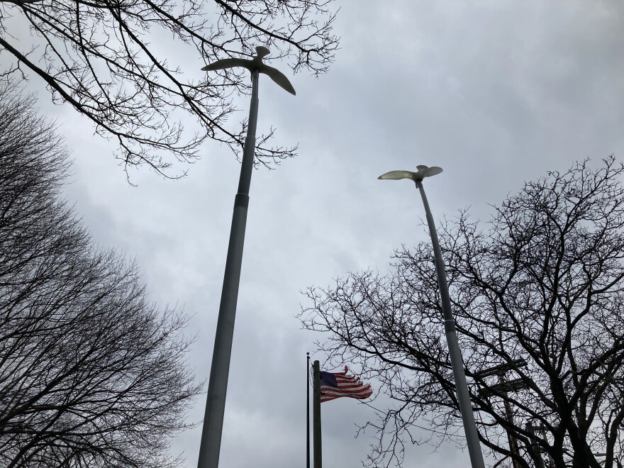 A memorial in Binghamton remembers the 13 people killed in a mass shooting April 3, 2009. It has a broken column in the middle – a symbol of life cut short – and 13 white birds flying away from it. Sarah Gager/WSKG