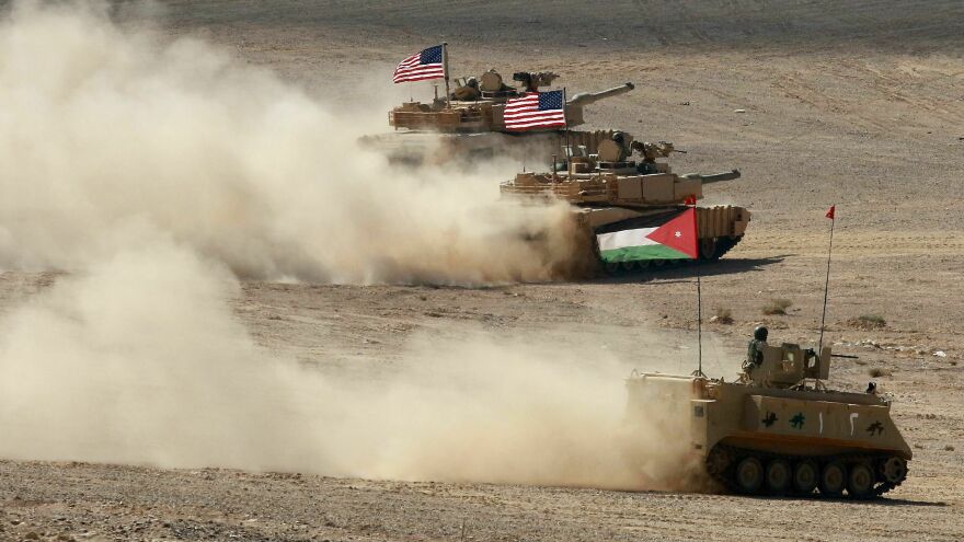 A Jordanian armored personnel carrier and U.S. tanks take part in the "Eager Lion" multinational military exercises in Jordan in September 2022.