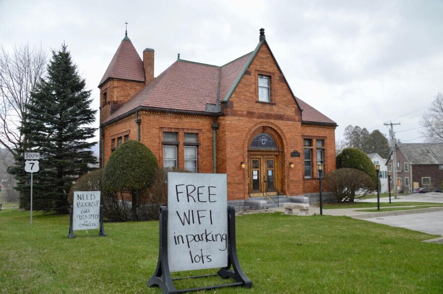 An orange brick building with a sign saying "free wifi in parking lots."