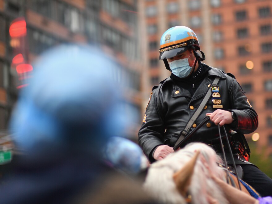 A mounted New York City police officer sits outside a hospital in Manhattan last month. Gov. Andrew Cuomo said he was encouraging officers to strictly enforce a state rule mandating face coverings in public.