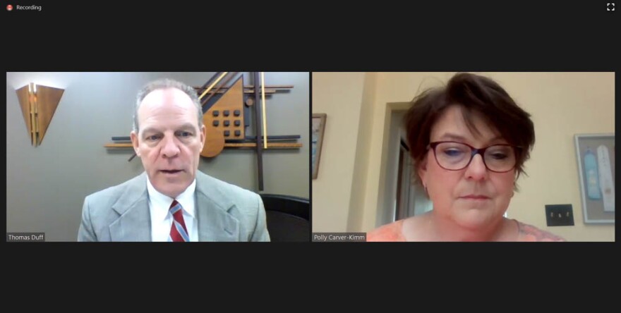 A man and a woman talking through zoom