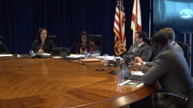 JEA Board of Directors meeing on a long table