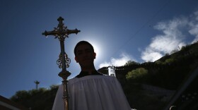 A Catholic procession begins a special 'Mass on the Border' along the U.S.-Mexico border fence on April 1, 2014 in Nogales, Arizona. Catholic bishops led by the Archbishop of Boston Cardinal Sean O'Malley held the mass to pray for comprehensive immigration reform and for those who have died along the border.  (Photo by John Moore/Getty Images)