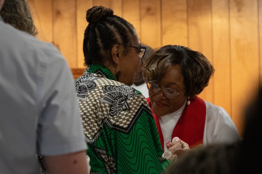 Attendees of the Rev. Dr. Pauli Murray's annual commemoration at St. Titus' Church line up before the church's rector, Rev. Valerie J. Mayo, to receive holy communion, Thursday, July 17, 2025, in Durham.