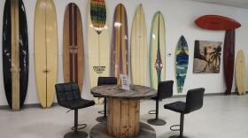 At the Surfing Florida Museum, visitors can sit at a cable-spool table and admire the historic boards.