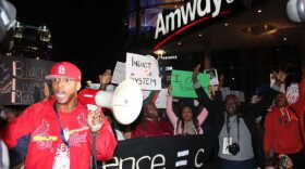 Protesters gathered in front of the Amway Center and staged a "die-in," where they lay on the ground holding signs of black men who were killed by police. Photo: Renata Sago, WMFE.