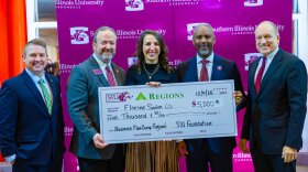 Heather Greenwood, center, owner of Florine Swim Co., receives the first-place check from (left to right) Mark Harmon, Regions Bank branch manager; Michael Jessup, Illinois Small Business Development Center director; SIU Chancellor Austin Lane and SIU System President Dan Mahony. (Photo by Erasmus Tornye)