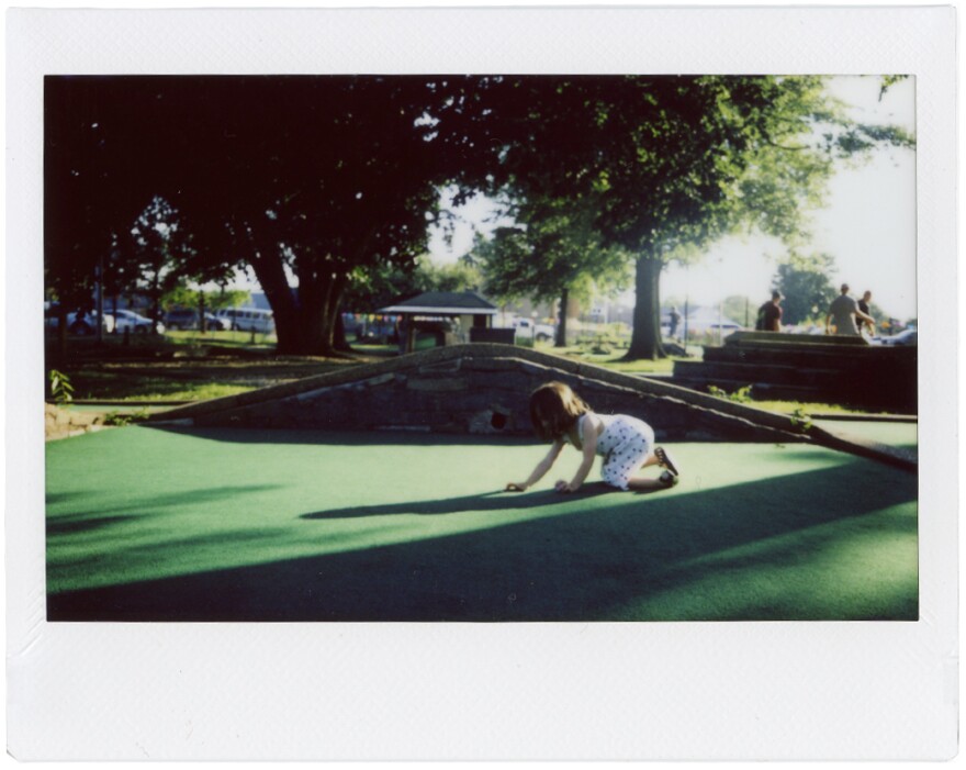 Eve Trujillo retrieves a golf ball. It was her first mini-golf outing.