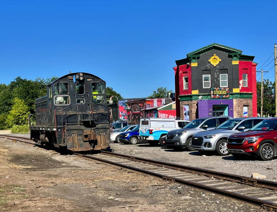 A freight locomotive on the Luzerne County-owned rail line passes South Wilkes-Barre businesses along Horton Street in 2024.