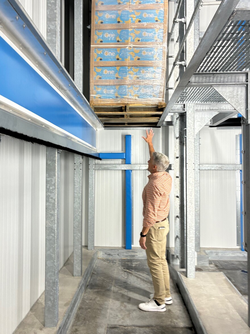 Robert Adams shows the inside of a ripening room. Ethylene is released into these rooms, and fans push the colorless gas into and around the banana boxes.