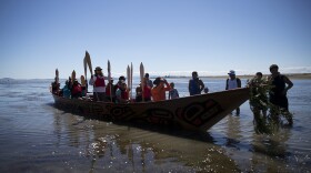 Members of the 'Emma canoe' arrive on the shore of the Tsawwassen Indian Reserve after the first leg of their multi-day canoe journey on Thursday, July 27, 2017, in Tsawwassen, British Columbia.