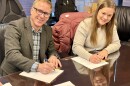 Canice Harte, the current Summit County Council chair, and Deputy County Manager Janna Young sign documents to close the 910 Cattle Ranch purchase Jan. 16, 2026.