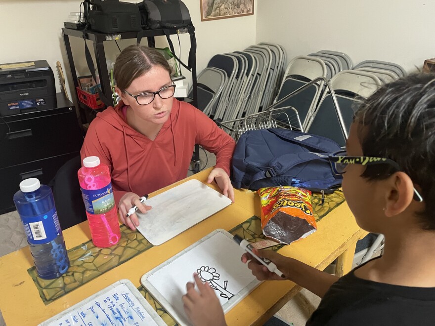Centro Latino After School Program Coordinator Anna Jones (left) helps Jonah Ortiz with his reading Tuesday, Oct. 25, 2022. She first writes a word, and he must read it and draw a picture of it. Ortiz's three siblings also have participated in Centro Latino.