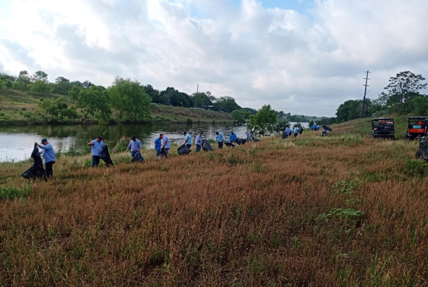 The Watershed and Park Operations team cleans up trash along the Mission Reach segment of the River Walk.