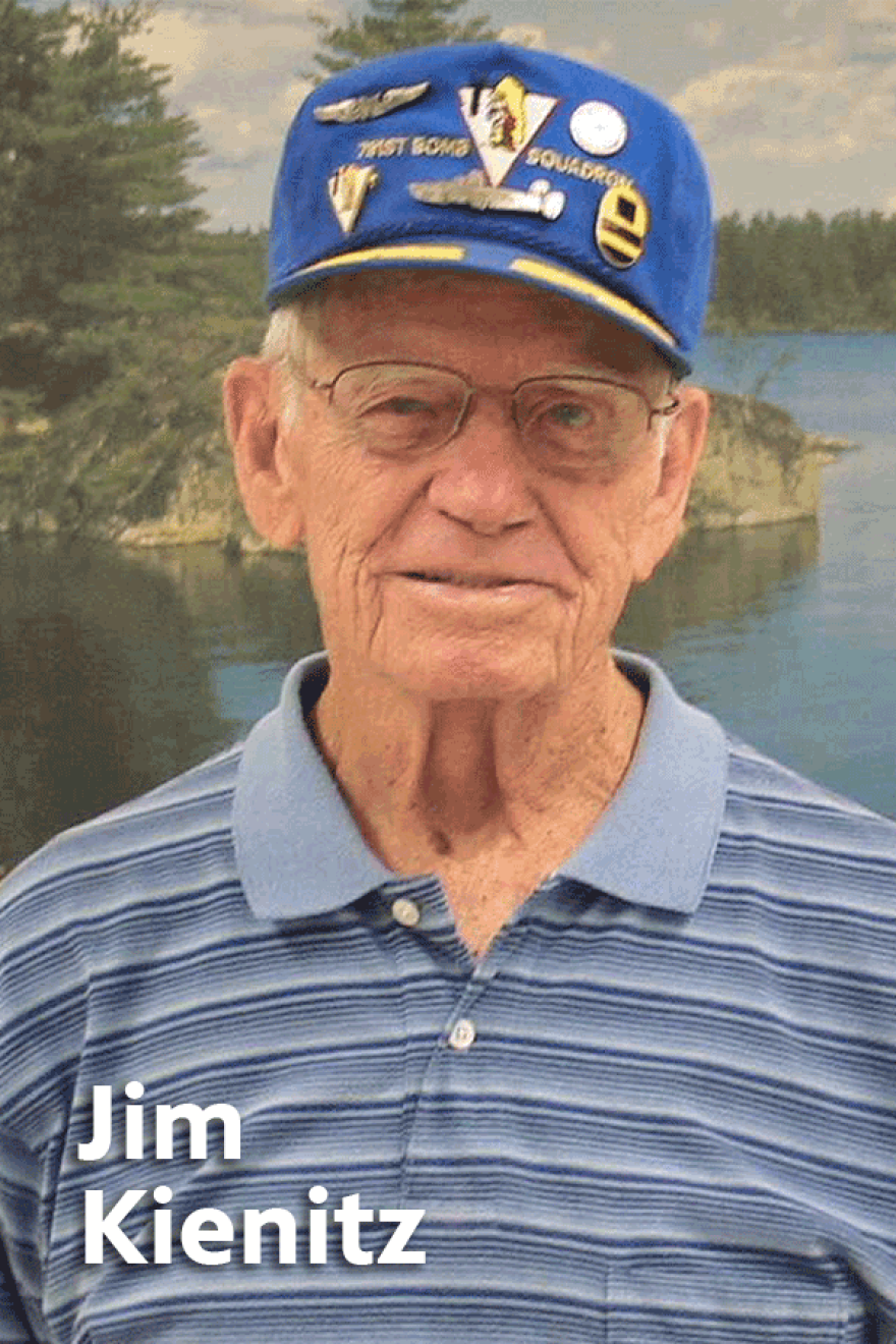 Image of a gray-haired James Kienitz in glasses, a blue and grey striped polo shirt and Veteran baseball cap
