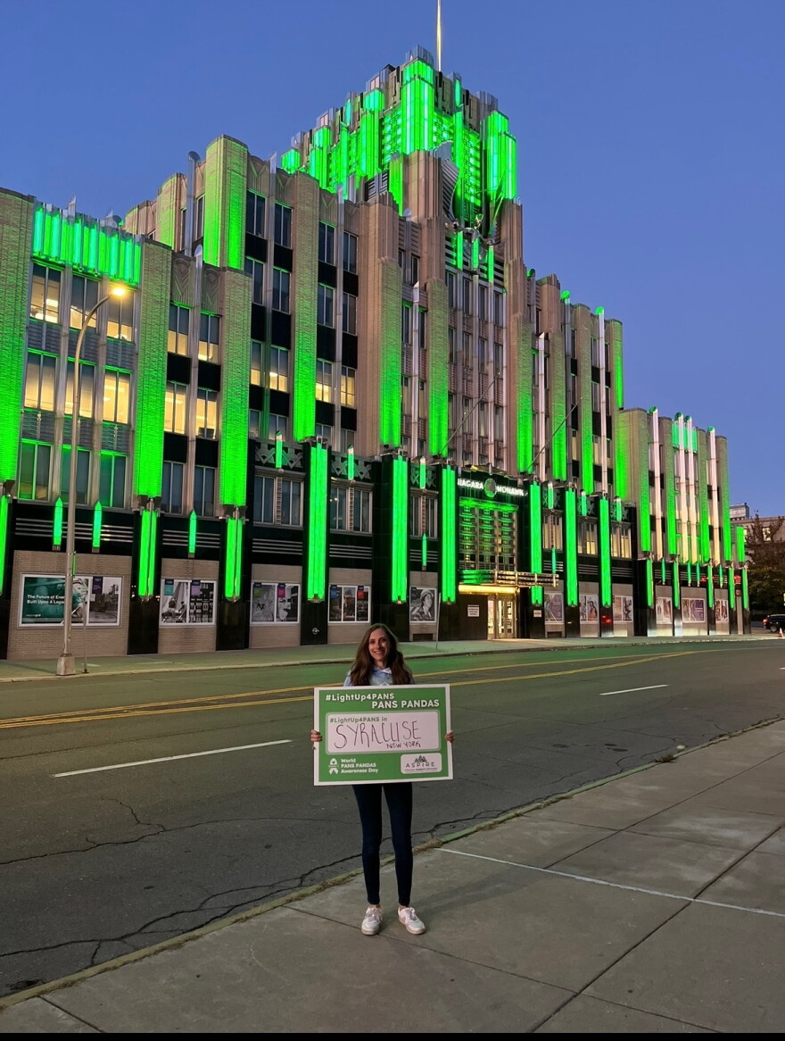 Barbara Shepard in front of the Niagara Mohawk Power Corporation building