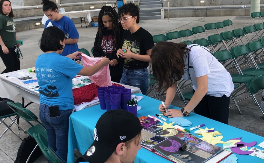 Students at Take Back the Night write messages for survivors of sexual assault.