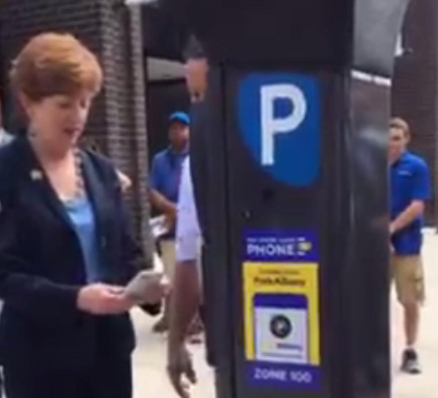 Albany Mayor Kathy Sheehan tries out the ParkAlbany app on one of the city's 12 new experimental pay-by-phone parking meters.