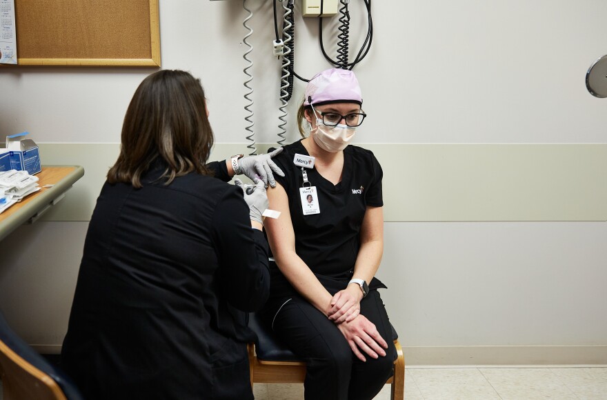 Nichole Boyer, clinical team leader at Mercy South Hospital, receives a coronavirus vaccination on Monday, December 14, 2020. Boyer was among the first in the St. Louis area to receive the vaccine.